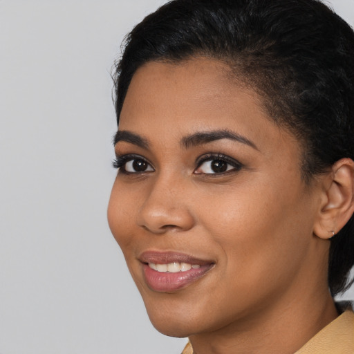 Joyful latino young-adult female with short  brown hair and brown eyes