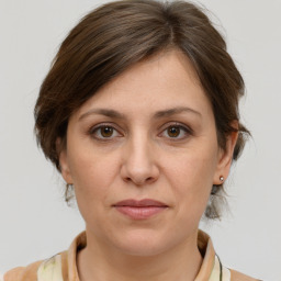 Joyful white adult female with medium  brown hair and grey eyes