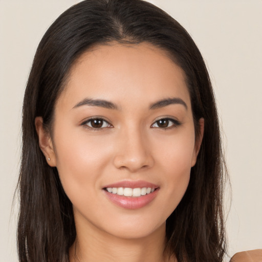 Joyful white young-adult female with long  brown hair and brown eyes