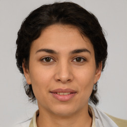 Joyful white young-adult female with medium  brown hair and brown eyes