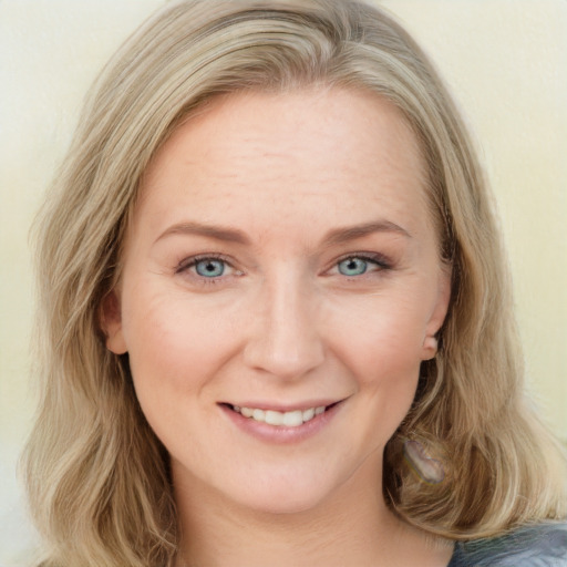 Joyful white young-adult female with long  brown hair and blue eyes