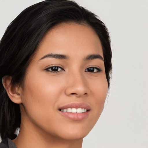 Joyful asian young-adult female with long  brown hair and brown eyes