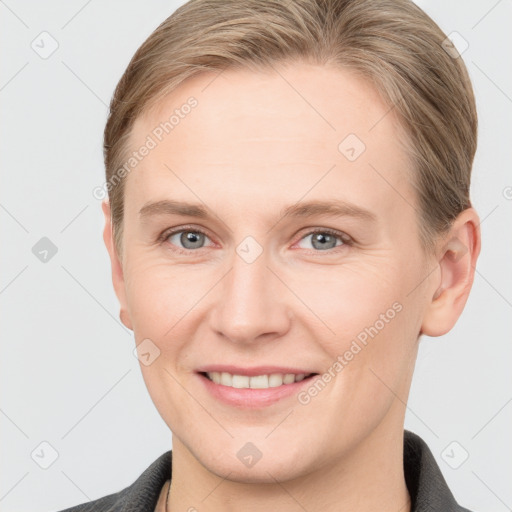 Joyful white young-adult female with short  brown hair and grey eyes