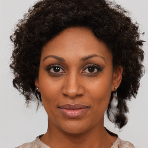 Joyful black young-adult female with medium  brown hair and brown eyes