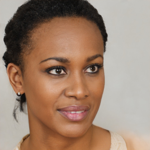 Joyful black young-adult female with short  brown hair and brown eyes