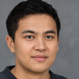 Joyful latino young-adult male with short  brown hair and brown eyes