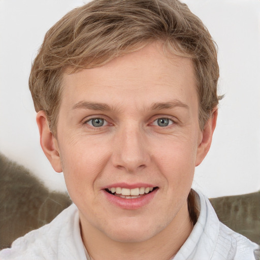 Joyful white adult male with short  brown hair and grey eyes