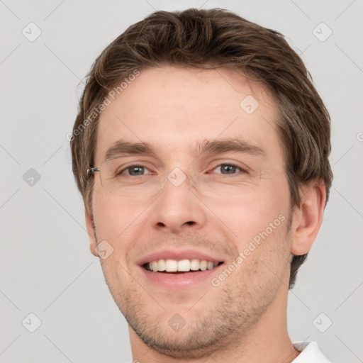 Joyful white young-adult male with short  brown hair and grey eyes