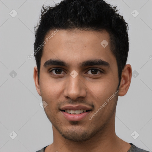 Joyful latino young-adult male with short  black hair and brown eyes