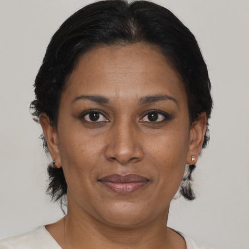Joyful black adult female with short  brown hair and brown eyes