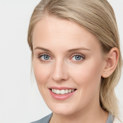 Joyful white young-adult female with medium  brown hair and blue eyes