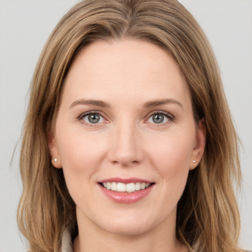 Joyful white young-adult female with long  brown hair and green eyes