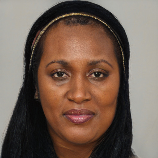 Joyful black adult female with long  brown hair and brown eyes