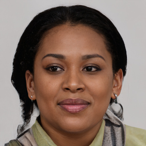 Joyful black young-adult female with medium  brown hair and brown eyes
