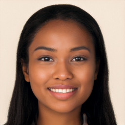 Joyful black young-adult female with long  black hair and brown eyes