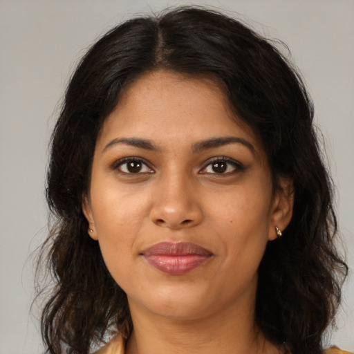 Joyful black young-adult female with medium  brown hair and brown eyes