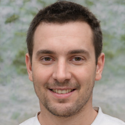 Joyful white young-adult male with short  brown hair and brown eyes