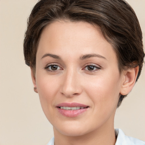 Joyful white young-adult female with short  brown hair and grey eyes