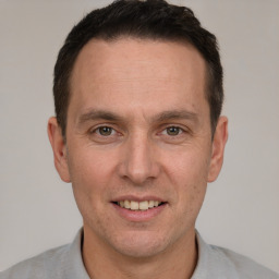 Joyful white adult male with short  brown hair and brown eyes