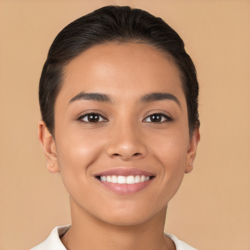 Joyful latino young-adult female with short  brown hair and brown eyes