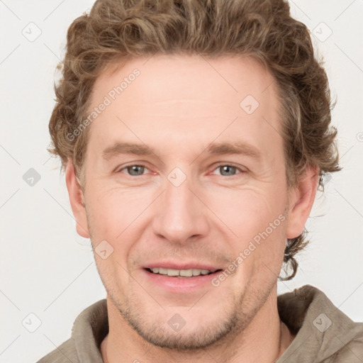 Joyful white adult male with short  brown hair and grey eyes