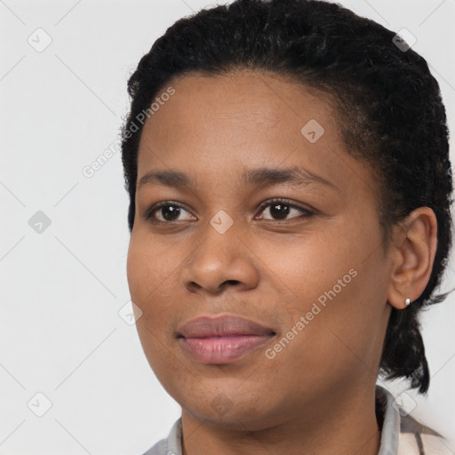 Joyful black young-adult female with short  black hair and brown eyes