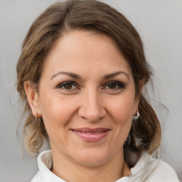 Joyful white adult female with medium  brown hair and brown eyes