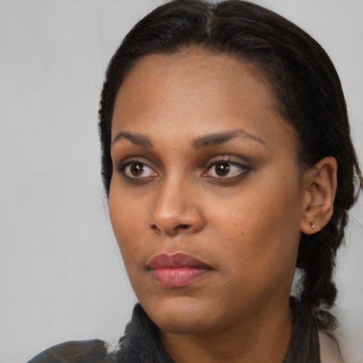 Neutral black young-adult female with medium  black hair and brown eyes