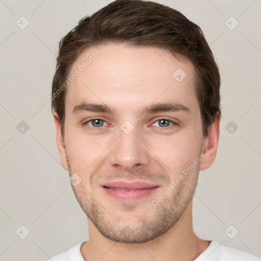 Joyful white young-adult male with short  brown hair and grey eyes