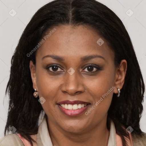 Joyful black adult female with long  brown hair and brown eyes