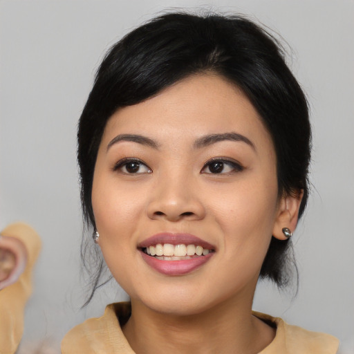Joyful asian young-adult female with medium  black hair and brown eyes