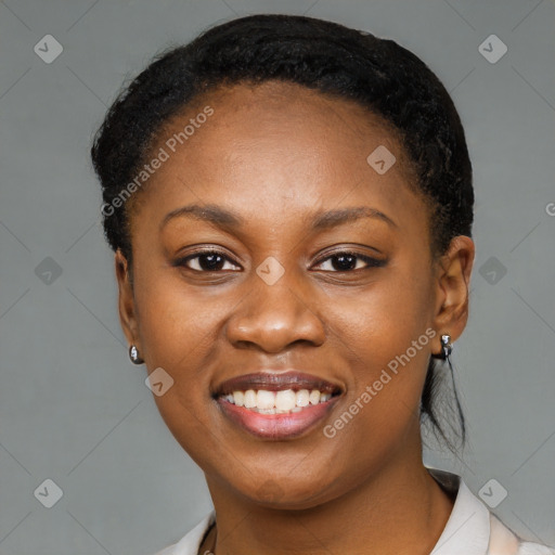 Joyful black young-adult female with short  black hair and brown eyes