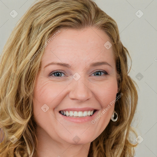 Joyful white young-adult female with long  brown hair and blue eyes