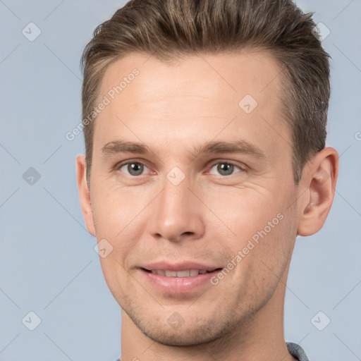 Joyful white adult male with short  brown hair and brown eyes