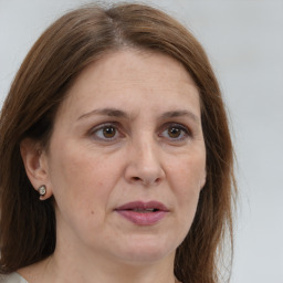 Joyful white adult female with medium  brown hair and grey eyes