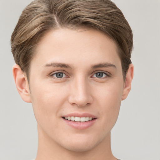 Joyful white young-adult female with short  brown hair and grey eyes