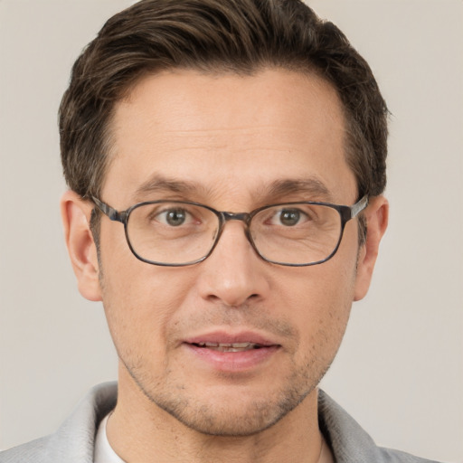 Joyful white adult male with short  brown hair and brown eyes