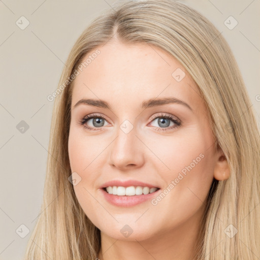 Joyful white young-adult female with long  brown hair and blue eyes