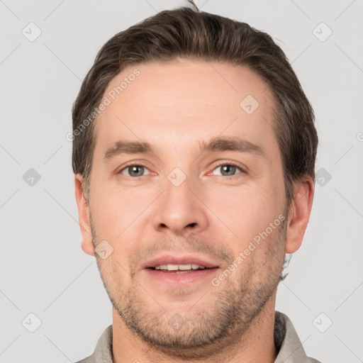 Joyful white young-adult male with short  brown hair and brown eyes