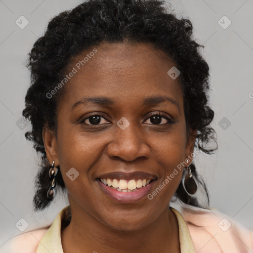 Joyful black young-adult female with long  brown hair and brown eyes