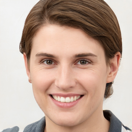 Joyful white young-adult female with medium  brown hair and grey eyes