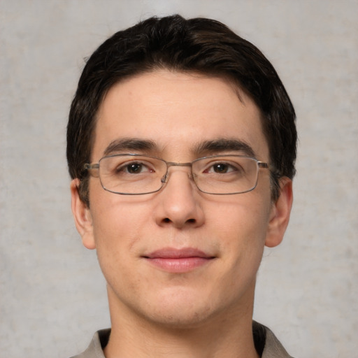 Joyful white young-adult male with short  black hair and brown eyes