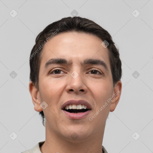 Joyful white young-adult male with short  black hair and brown eyes