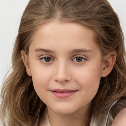 Joyful white child female with long  brown hair and brown eyes