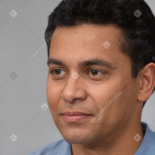 Joyful white adult male with short  black hair and brown eyes