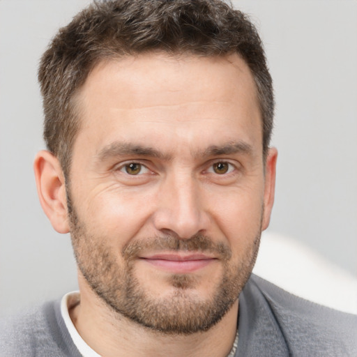 Joyful white adult male with short  brown hair and brown eyes