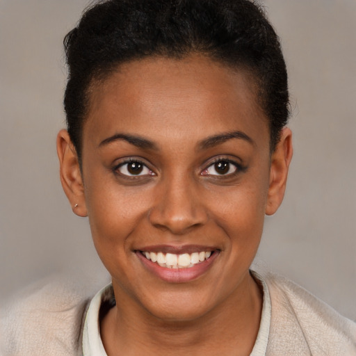 Joyful black young-adult female with short  brown hair and brown eyes