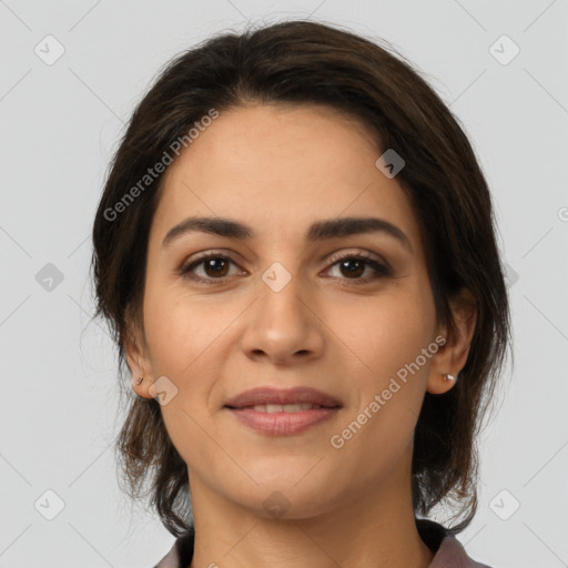 Joyful latino young-adult female with medium  brown hair and brown eyes