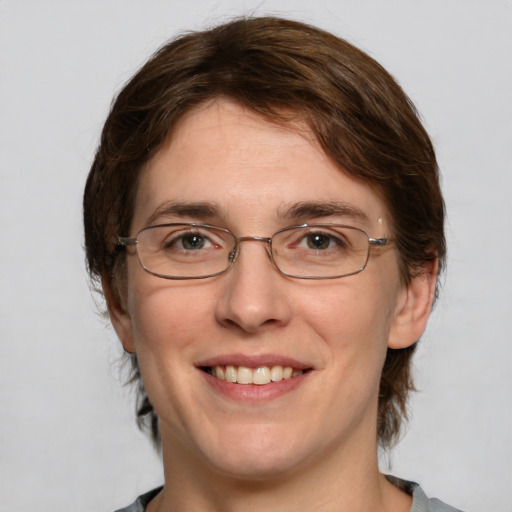 Joyful white adult female with medium  brown hair and grey eyes