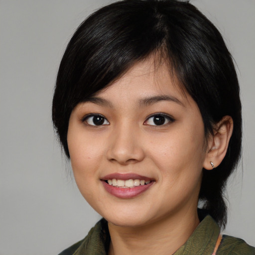 Joyful asian young-adult female with medium  black hair and brown eyes